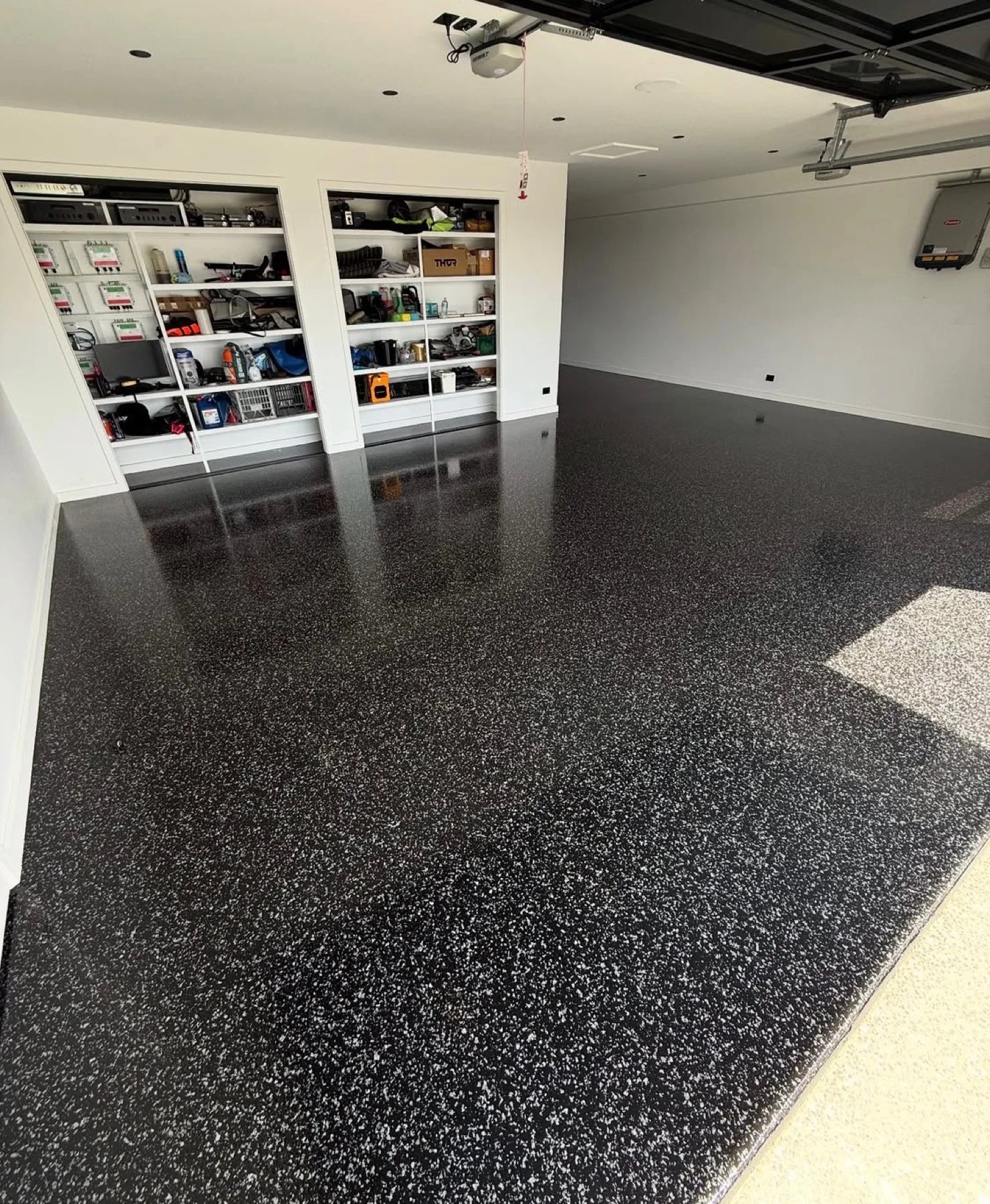 Black flake epoxy garage floor with built-in shelving in Goldsboro, North Carolina