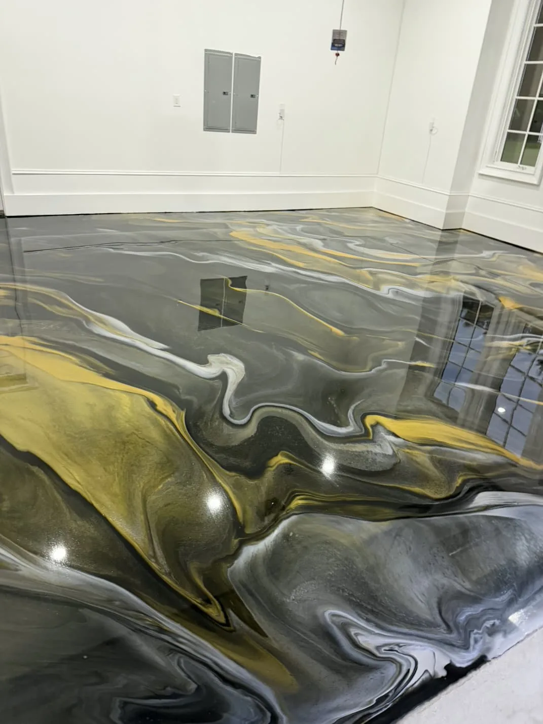Gold and black metallic epoxy garage floor in Goldsboro, North Carolina