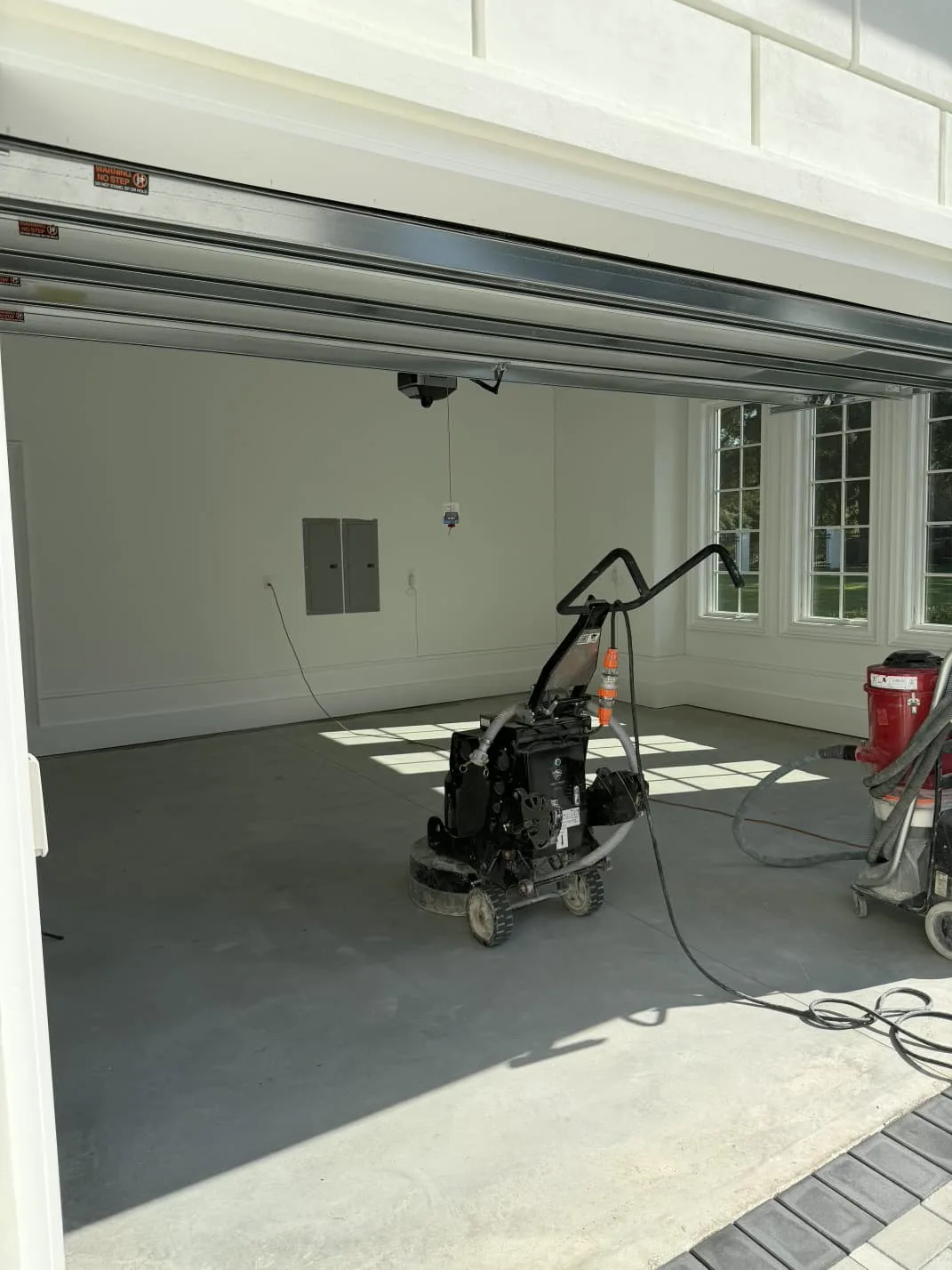 Bare garage concrete being ground before epoxy in Goldsboro, North Carolina